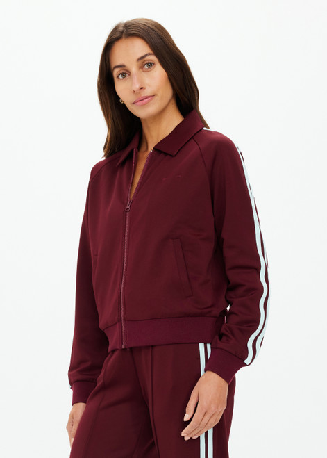 THE UPSIDE women's merlot Vitesse Pari Zip Jacket is a zip through sport jacket in a slinky fabrication with mesh stripes down sides in Mint. Made for lifestyle.