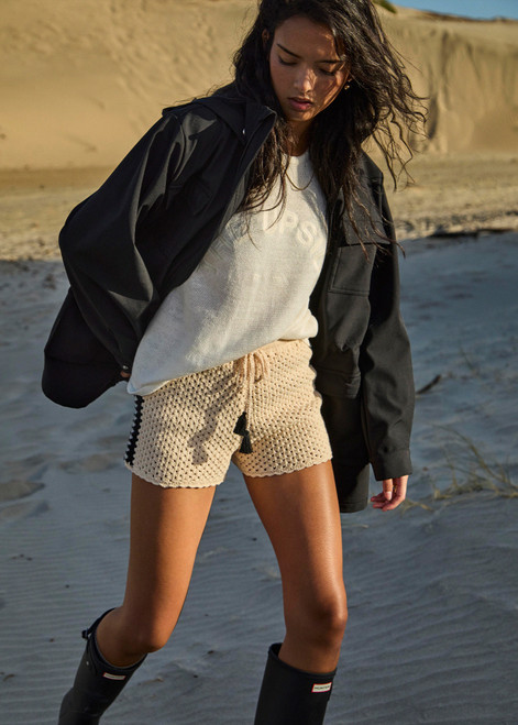 THE UPSIDE women's black Freddie Fleece Lined Anorak is made from bonded water resistant fabric with internal warm polar fleece and features external pockets with flap closure and drawcord with toggles to cinch in waist.