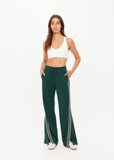 THE UPSIDE women's green Roma Pant is a highwaisted, true-to-size fit made in double-faced jersey and features contrast tape down side seams, side pockets and an elasticated waistband with drawcord.
