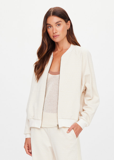 THE UPSIDE women's cream Navar Isabella Bomber Jacket is an oversized fit with raglan sleeves in our castilla "TU" design and features a front patch pocket, crafted from a knitted jacquard fabrication. Made for everyday wear.
