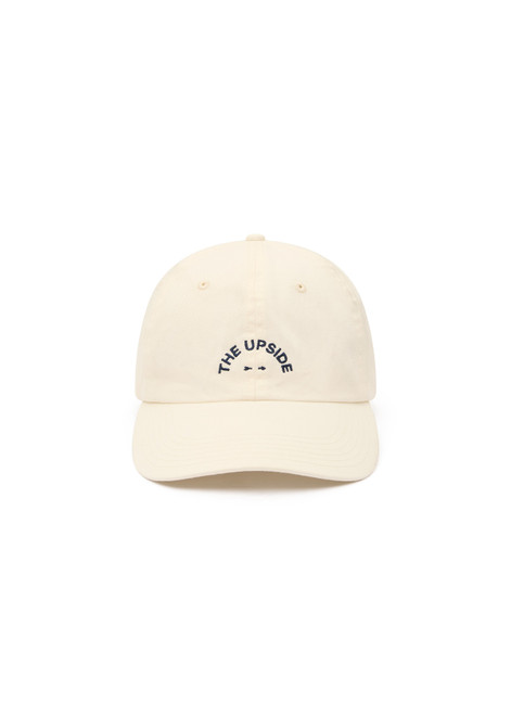 THE UPSIDE women's cream 100% cotton Marlon Soft Cap has an adjustable navy paracord tie at back with gold metal eyelets. Made for lifestyle.