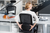 Person adjusting the lumbar support on a HÅG SoFi ergonomic chair while seated at a desk