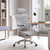 Light gray ergonomic mesh office chair with headrest and adjustable arms in a modern home office workspace
