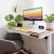 Rise Up Essential electric standing desk in a compact home office with a 47-inch maple desktop.