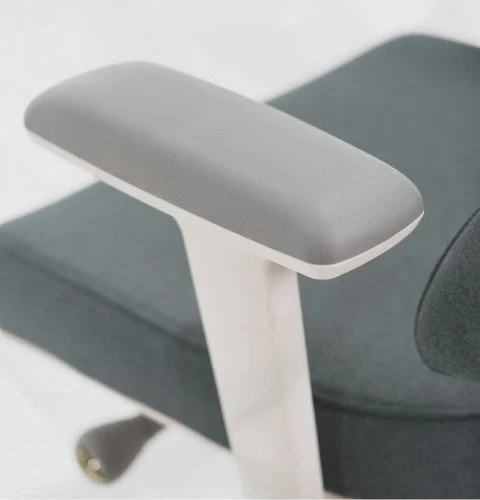 Close-up of a cushioned Anthros adjustable armrest with light-colored frame
