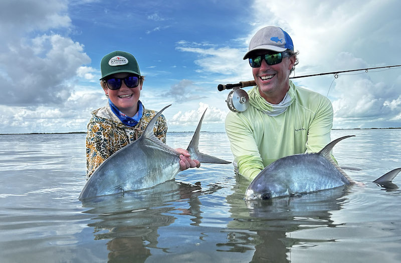 Two fly fishing anglers holding Permit caught while fly fishing in mexico