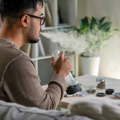 Person taking a large, smooth hit from a glass bong