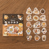 Calico Cat Welcome Meow package with individual die-cut cat and cafe food stickers on a wood grain background