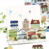 House stickers arranged side by side to form a mini street scene decorating a card