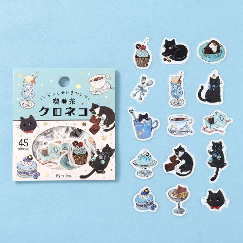 Black Cat Welcome Meow package with individual die-cut cat and dessert stickers on a light blue background