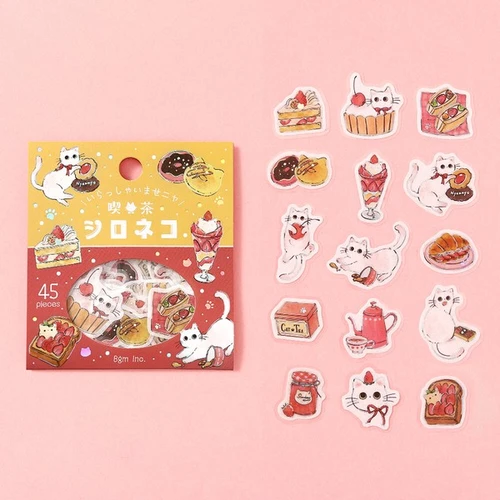 White Cat Welcome Meow package with individual die-cut cat and dessert stickers on a pink background