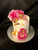 The Sweet Elegance cake is a stunning four-layer vanilla  cake, each layer filled with a rich buttercream. The cake is decorated with delicate pink silk flowers that add a lovely pop of color. The top of the cake is adorned with edible gold flakes, adding a touch of glamour and sophistication. In addition, the cake features beautiful gold butterfly decorations, each one carefully crafted with attention to detail. The combination of flavors and textures in this cake is simply exquisite, making it the perfect choice for any special occasion.