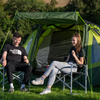 A male and a female sat outside of the Abberley XL 4 Berth Tent by OLPRO at a campsite.