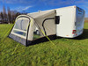 An image of the View Lite 390 Caravan Awning from OLPRO attached to a caravan in a field.