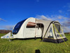 The OLPRO View Lite Breeze 260 Caravan Awning pictured attached to a caravan in a field.