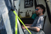 A man sits inside the Loopo Breeze® XL v2 Motorhome Awning by OLPRO, he is sat in a camping chair