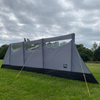 Inflatable Charcoal Windbreak from OLPRO pictured in a camping field.