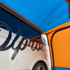 Inside the tunnel of an Uno Breeze v2 Campervan Awning whilst it is attached to a VolksWagen T5 ,imageset:Orange