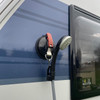 The awning suction cup fastener being used with the OLPRO portable shower on the side of a caravan.