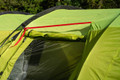 A close up image showing a red strap that attaches the Abberley XL Extension to the Abberley XL Tunnel Tent by OLPRO.