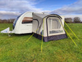 An image of the View Lite 260 Caravan Awning from OLPRO in a field attached to a caravan.