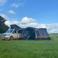 The Cocoon Breeze® v2 Campervan Awning OLPRO on a campsite against a bluesky imageset:Charcoal