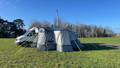 The Cocoon Breeze® XL v2 Motorhome Awning (Grey) from OLPRO pictured in a campsite attached to a VW Crafter Camper Van