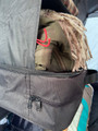 A closeup of the storage bag in the Camping Organiser with Shelves and Storage bag which contains clothing and blankets.