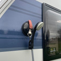 The awning suction cup fastener being used with the OLPRO portable shower on the side of a caravan.