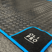OLPRO Awning Tunnel Mat with black rubber and blue edge trim on the floor with OLPRO Logo in the corner of the mat.