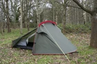 The OLPRO Solo Lightweight backpacking 1 Person Tent being used in a wild camping situation with a backdrop of trees.