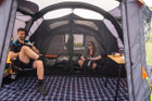 A male and female inside of the Abberley Xl Breeze® 4 Berth Inflatable Tent from OLPRO showing the inner bedroom with sleeping bags stowed inside of them.
