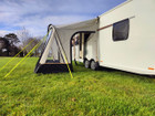 An image of the View Lite 260 Caravan Awning from OLPRO in a field attached to a caravan.