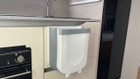 An image of the 9L Folding Camping  Bin Hanging or Free Standing from OLPRO being used in a caravan.