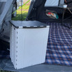 The OLPRO 30L Foldable Dustbin in an awning with its lid closed. It collapses flat for convenience when not in use, making it an ideal bin for camping or a versatile storage solution.
