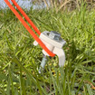 A screw-in hard ground peg secures a tent's guyline firmly in place.