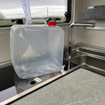 Image of the Folding 10L Water Carrier by OLPRO on the worktop of a camper.