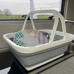 The collapsible washing bowl being used within a caravan from OLPRO with Melamine inside of it.