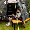 Image of Henwick Padded Folding Camp Chair Orange & Black by OLPRO, lifestyle with atwo young ben camping.
