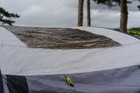 A closeup of the OLPRO Blakedown Breeze 4 Berth Inflatable Tent skylight with beads of rain on it.