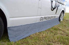 An image of the Awning Skirt and Draught Excluder Size Small from OLPRO attached to a VW Campervan.