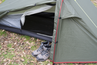 The OLPRO Solo Lightweight backpacking 1 Person Tent  with its door open and walking boots stored within the storage areas of the tent.