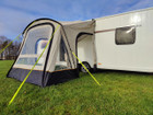 An image of the View Lite 260 Caravan Awning from OLPRO in a field attached to a caravan.
