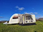 The OLPRO View Lite Breeze 260 Caravan Awning pictured attached to a caravan in a field.