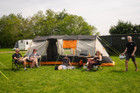 A group of friends gather outside the Wichenford 8.0 poled tent