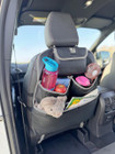 The Rear Single Seat Storage Organiser in Grey by OLPRO being fitted onto the rear of the passenger seat of VW vehicle with some beauty products.