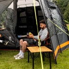 Image of Henwick Padded Folding Camp Chair Orange & Black by OLPRO, lifestyle with atwo young ben camping.