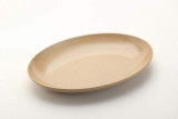 Husk Oval Plate by OLPRO, pictured on a plain background showing its curved edges. Lightweight and less breakable than pot and compostable.