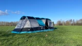 The Stafford 8.0 OLPRO x Ed Stafford sits on a campsite against a blue sky.