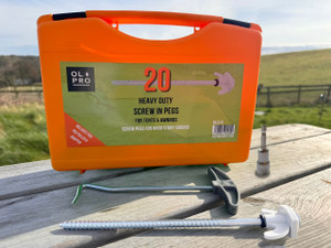 Depiction of OLPRO Screw in Hard Ground Rock Pegs within its case, displayed on a table against the backdrop of open countryside. The image showcases the pegs as well as the accompanying Adaptor and Peg Puller. The Adaptor is designed to fit any drill, facilitating the insertion of the pegs into hard ground. Pack of 20 pegs, adaptor and peg puller. Depiction of OLPRO Screw in Hard Ground Rock Pegs within its case, displayed on a table against the backdrop of open countryside. The image showcases the pegs as well as the accompanying Adaptor and Peg Puller. The Adaptor is designed to fit any drill, facilitating the insertion of the pegs into hard ground. Pack of 20 pegs, adaptor and peg puller.